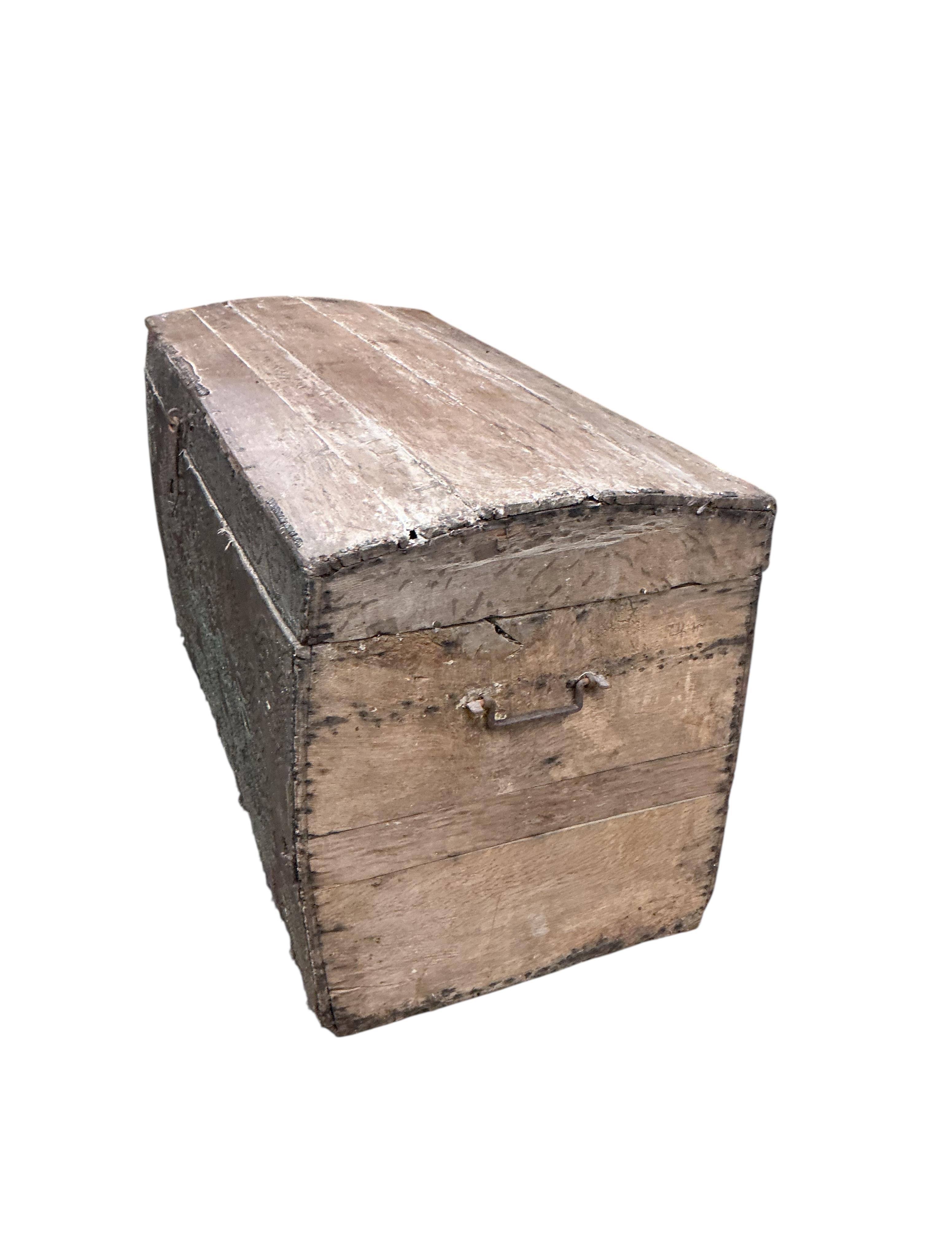 An 18th century oak domed trunk the front with the remnants of studded leather work, width 118cm, depth 53cm, height 65cm